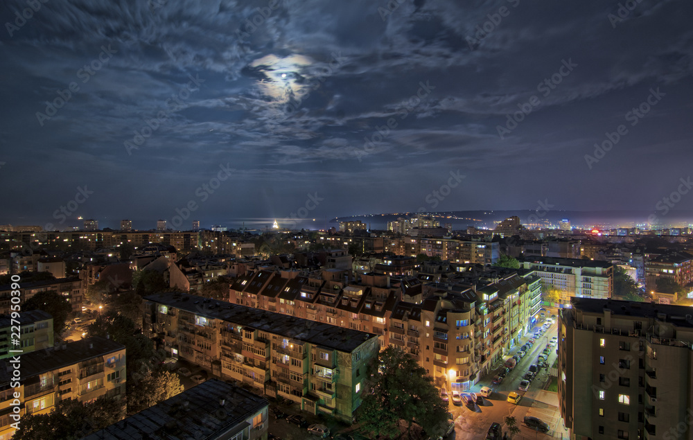 Fototapeta premium Panorama of Varna in the full moon light , dramatic cityscape.