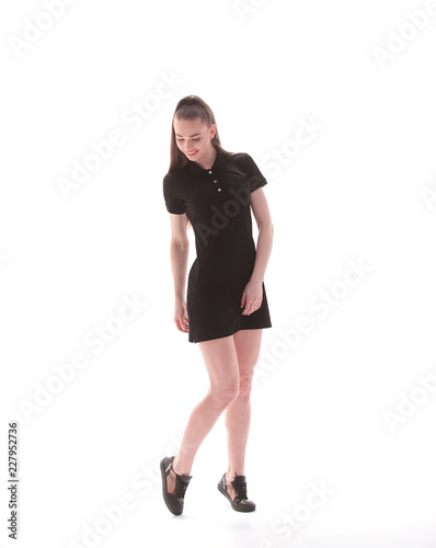 beautiful young woman in a short black dress .isolated on white