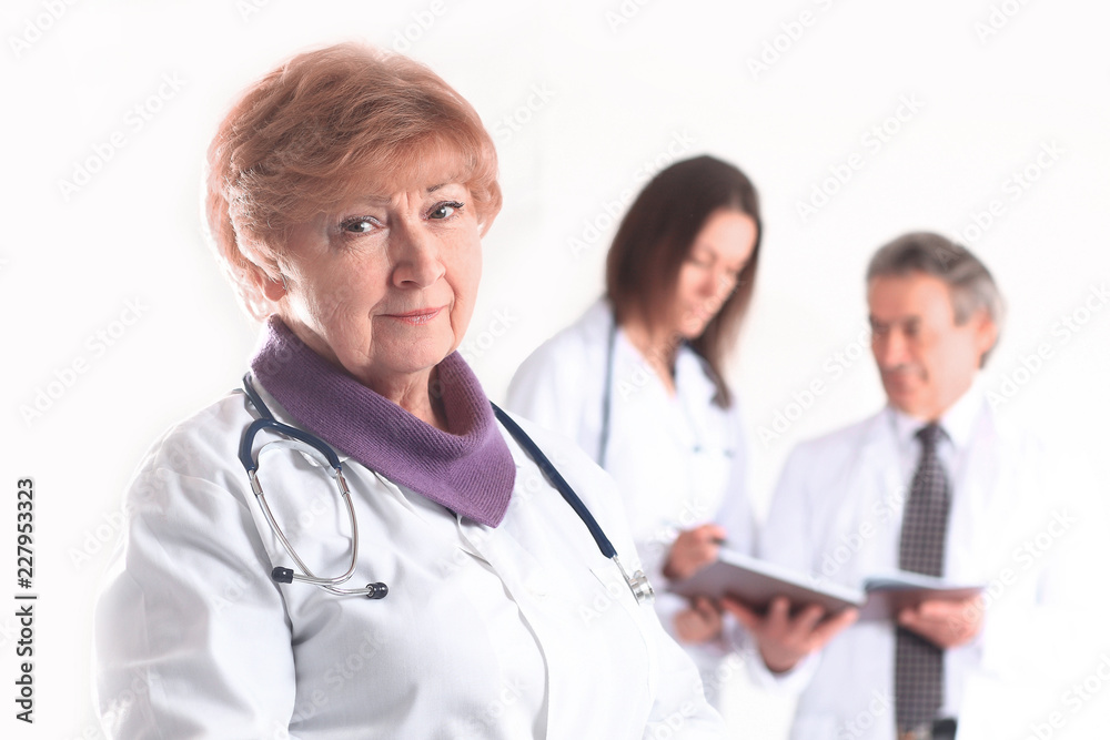 adult female doctor therapist on blurred background of colleagues adult female doctor therapist on blurred background of colleagues