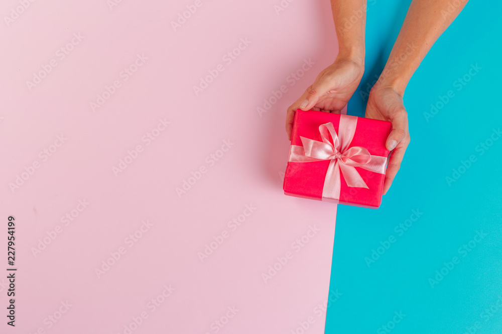 Woman holding gift box on color background Woman holding gift box on color background