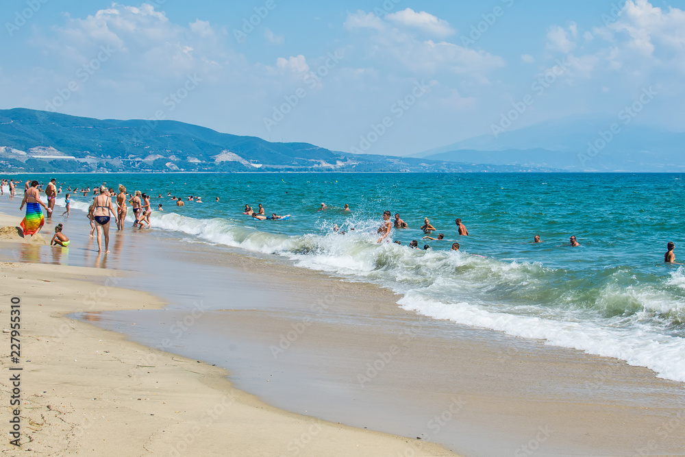 Fototapeta premium Asprovalta, Greece - August 20, 2018: Asprovalta and New Vrasna resort, Asprovalta beach. Sea view to Asprovalta at the foot of the green hills.