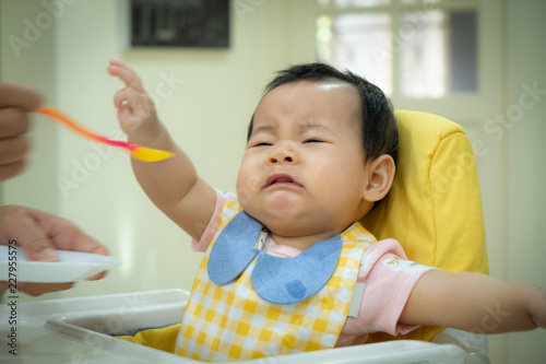 Asian baby girl refusing to eat food.tradition weaning