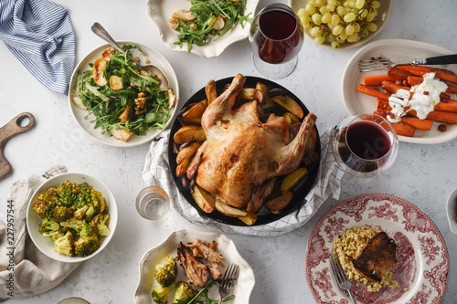 Big festive dinner with roasted chicken and various garnishing. Overhead view, celebration concept