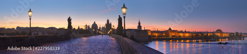 Photography Panoramic image of Charles bridge and Vltava river at dawn