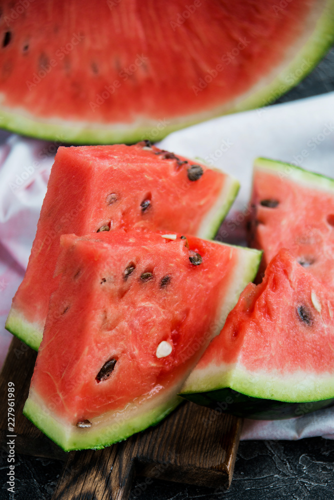 Slices of fresh ripe watermelon on a dark background. Slices of fresh ripe watermelon on a dark background.