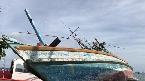 Fishing boats in the harbor. Shipwreck on the beach. An old wrecked wooden boat near the shore with the beach.