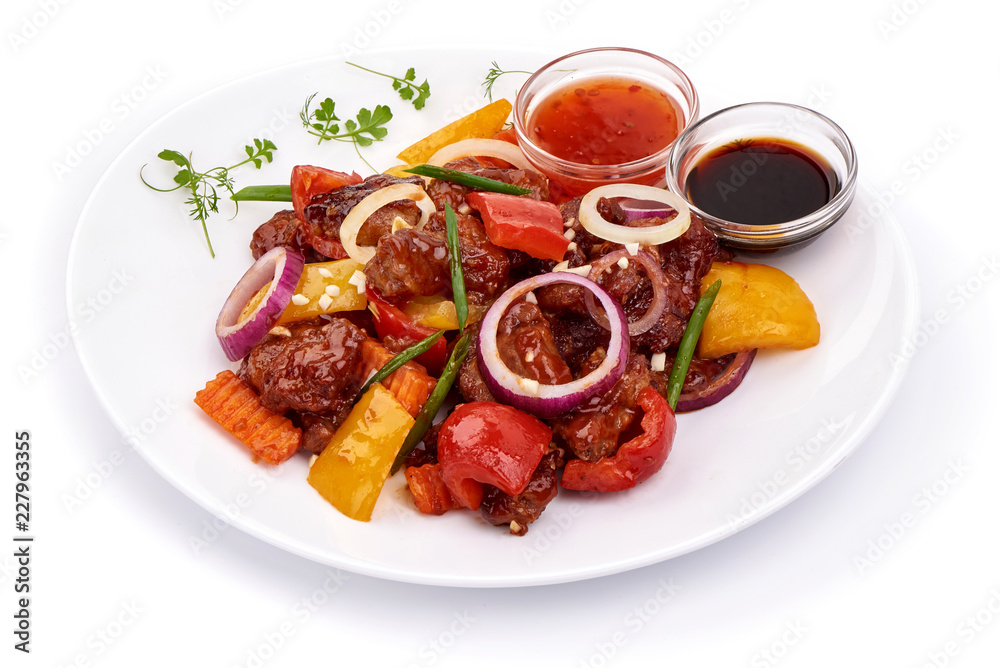 Tradicional Chinese recipes WOK. Roast Sweet and Sour Pork with vegetables in a plate. Isolated on white background. Tradicional Chinese recipes WOK. Roast Sweet and Sour Pork with vegetables in a plate. Isolated on white background.