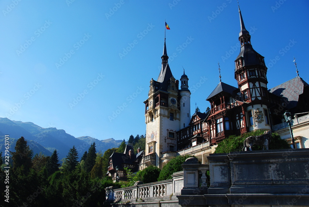 Peles Castle in summer sorrounded by Carpathian Mountains, Romania Peles Castle in summer sorrounded by Carpathian Mountains, Romania