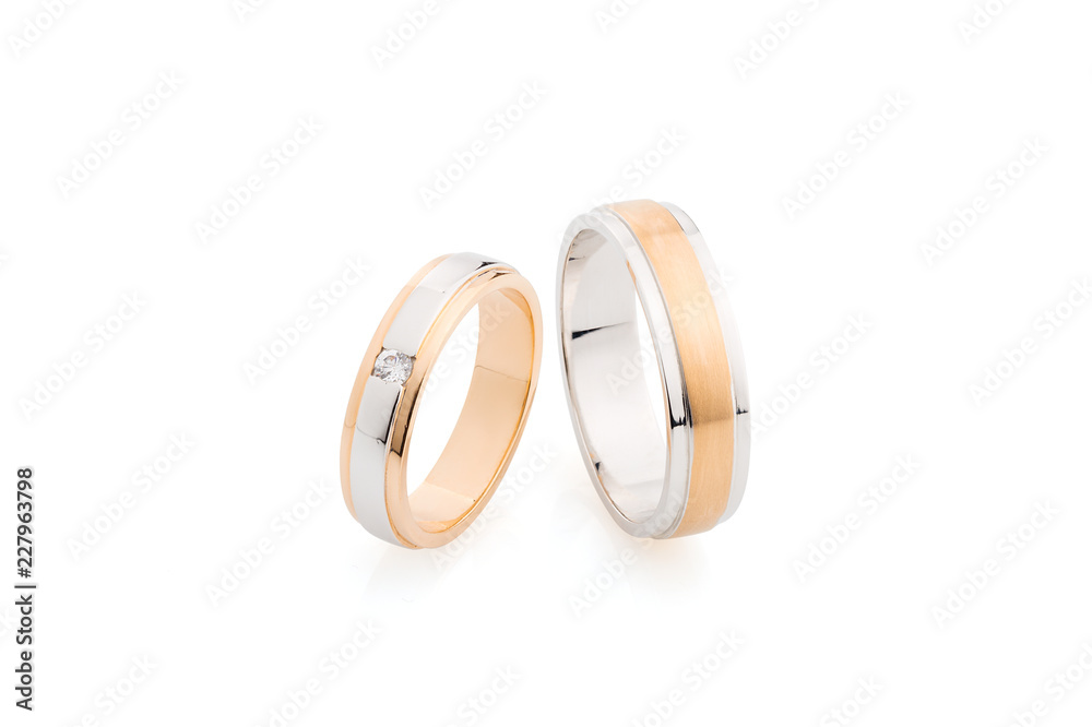 Pair of pink gold and white gold wedding rings isolated on white background Pair of pink gold and white gold wedding rings isolated on white background