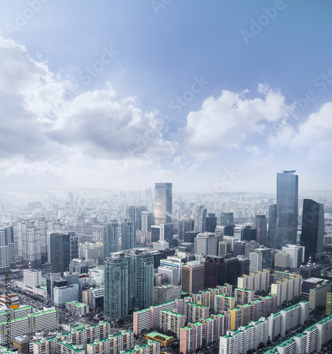 Seoul cityscapes  skyline  high rise office buildings and skyscrapers in Seoul city  winter daylight  top view in winter  Seoul  Republic of Korea  in mist winter season with blue sky and cloud