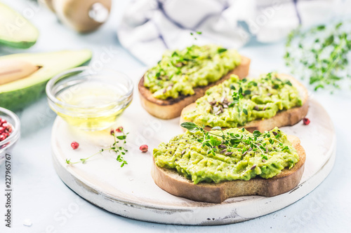 Smashed avocado sea salt and herbs toast. Selective fcous, space for text.
