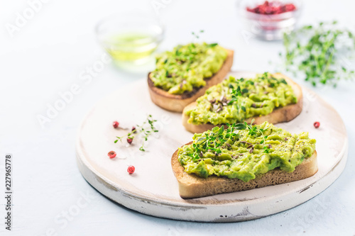 Smashed avocado sea salt and herbs toast. Selective fcous, space for text.