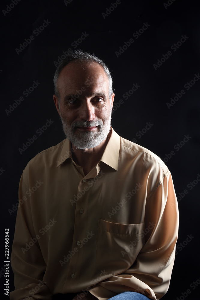 portrait of a middle aged man on black
