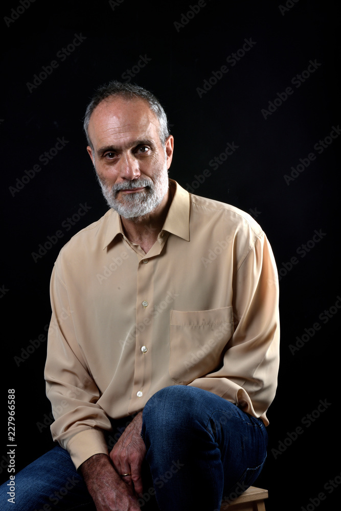 Fototapeta premium portrait of a middle aged man on black