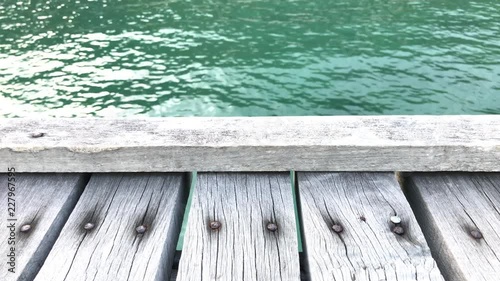 The texture of old wooden bridge and beautiful wave background.