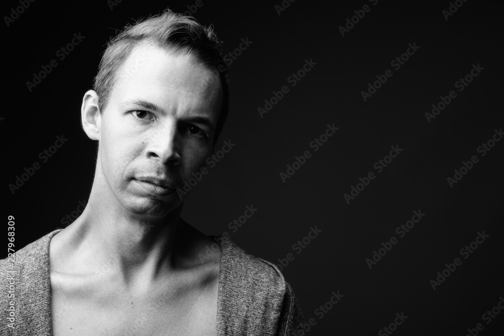 Rebellious man against black background in black and white