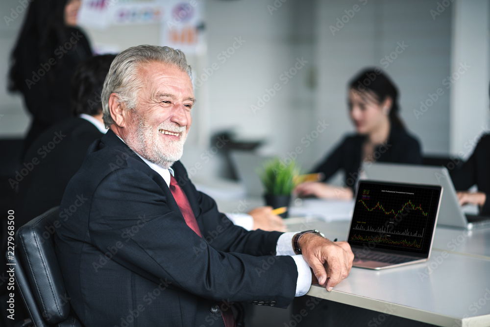 Mature Businessman Smiling to Working with Business People Teamwork in an Office - Corporate Concept Mature Businessman Smiling to Working with Business People Teamwork in an Office - Corporate Concept