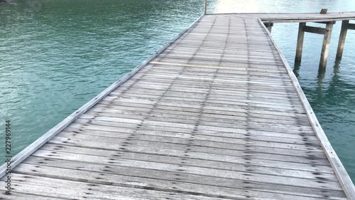 Old Wooden Bridge from beach to the sea.