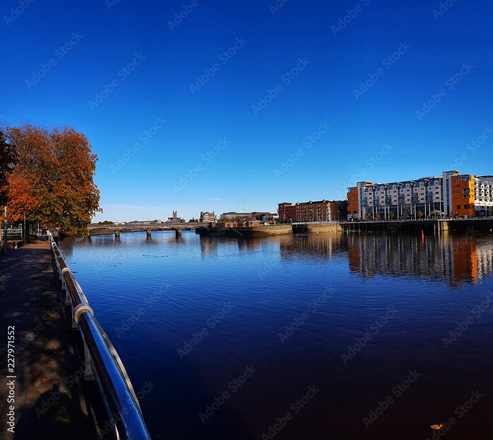limerick city skyline ireland. beautiful limerick urban cityscape over the river shannon on a sunny day with blue skies.