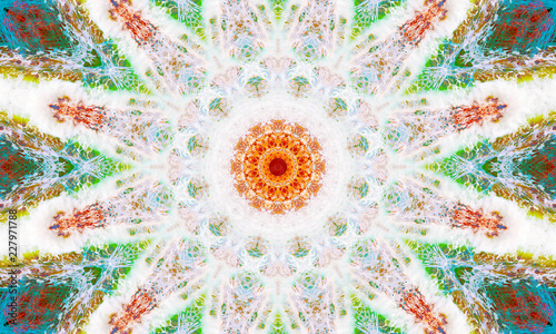 White, orange, and green mandala Art with repetitive shapes and many geometric patterns.