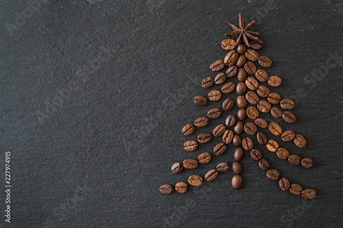 Christmas tree lined from coffee beans on a dark background