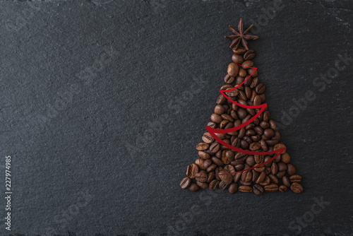 Christmas tree lined from coffee beans on a dark background