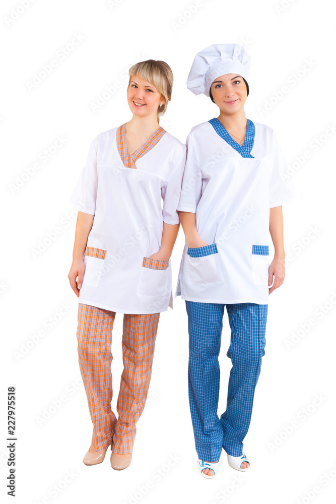 two young women in cook costumes isolated on white background in full growth look into camera two young women in cook costumes isolated on white background in full growth look into camera