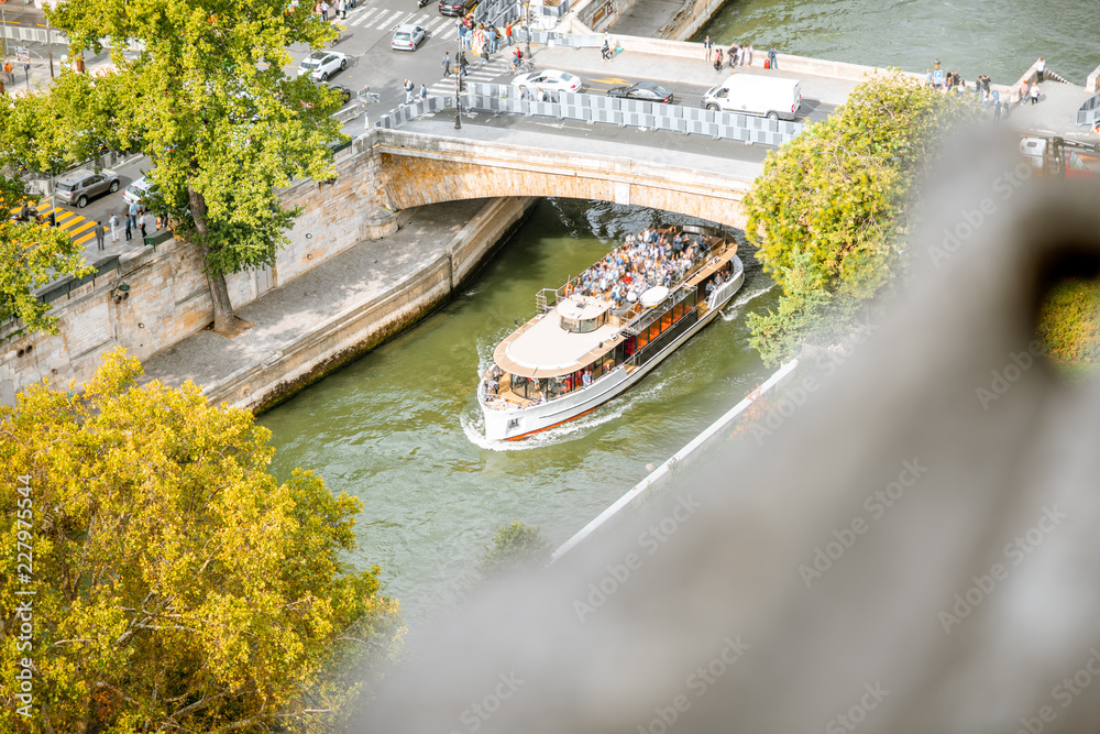 Top view on the Seine river with tourist ship sailing under the bridge in Paris