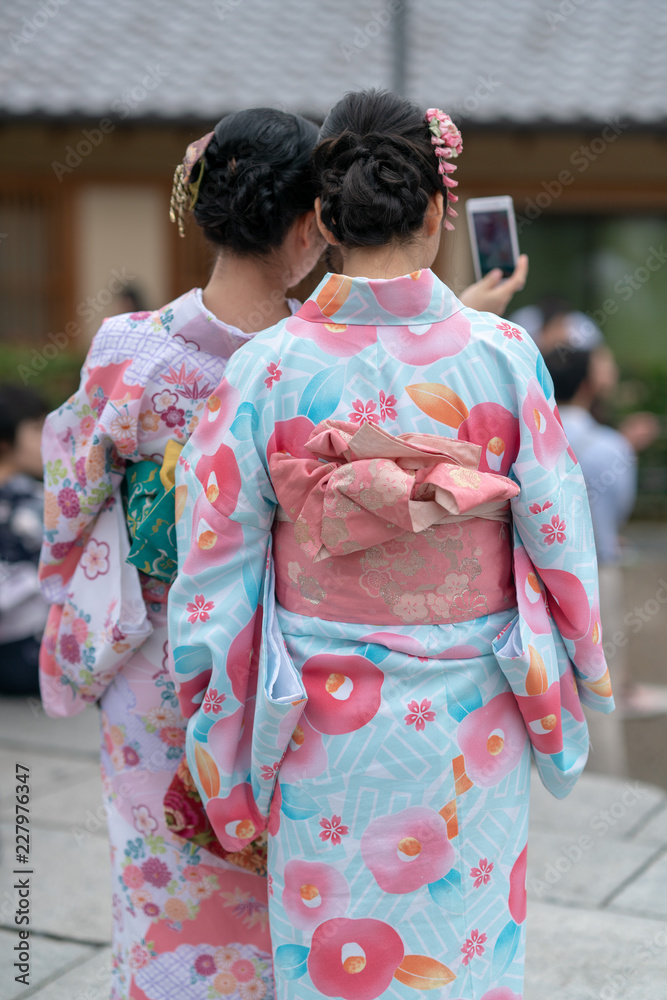 Girls in geisha costume taking a selfie