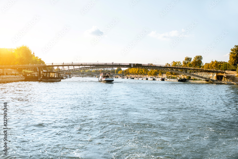 Fototapeta premium Landscape view on the riverside from the boat sailing on Seine river during the sunset in Paris