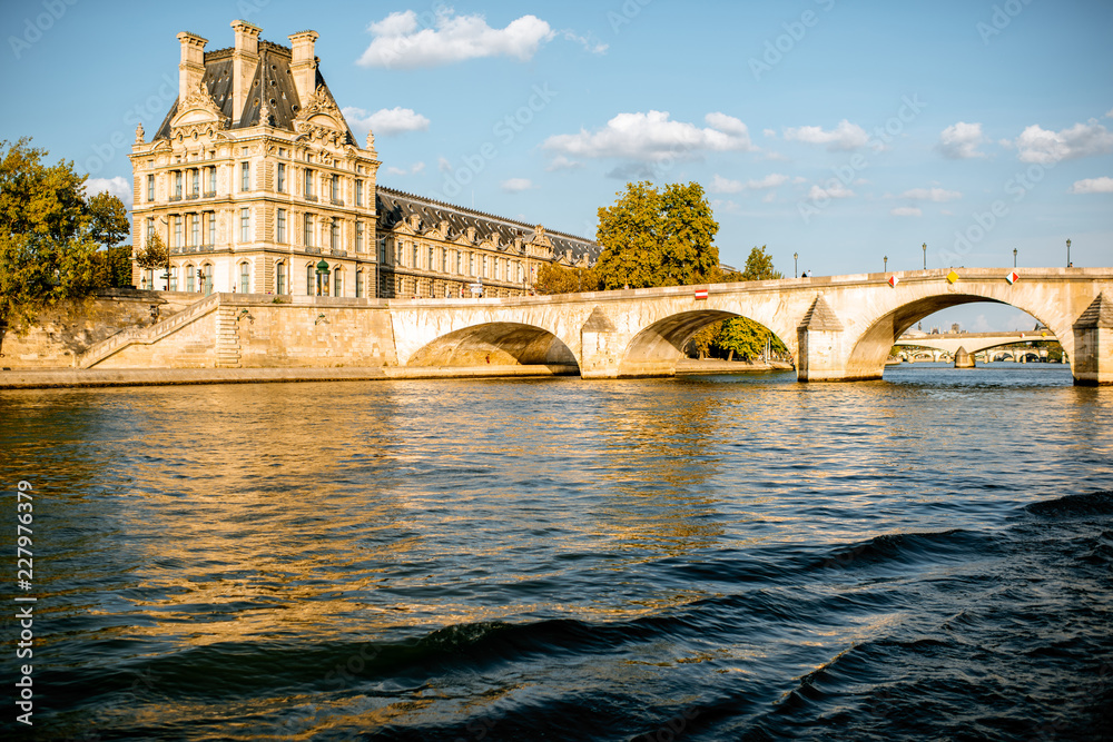 View on the riverside from the boat sailing on Seine river during the sunset in Paris