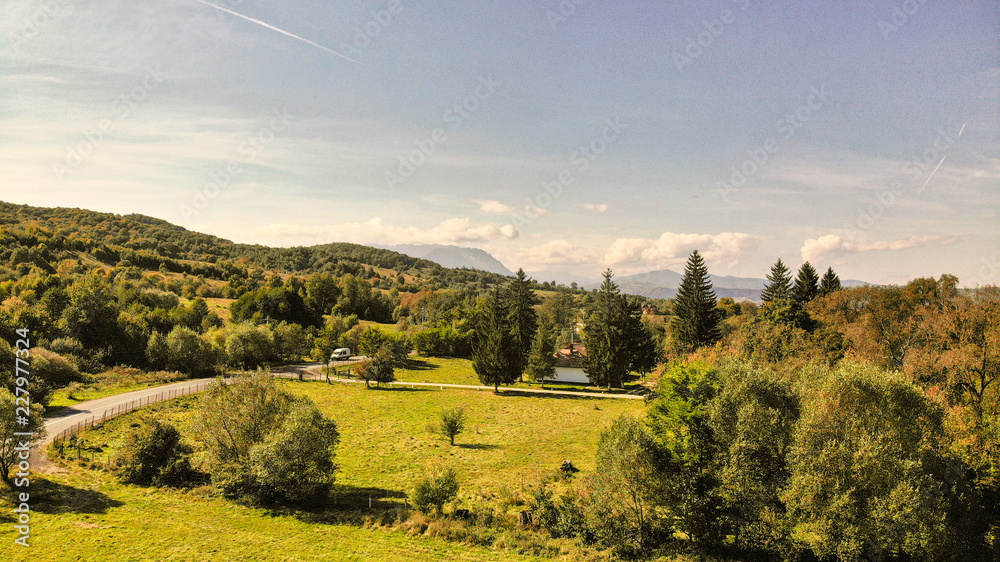 Aerial view of beautiful Transylvania. Carpathian mountains in autumn, sunset with beautiful collors and clouds.