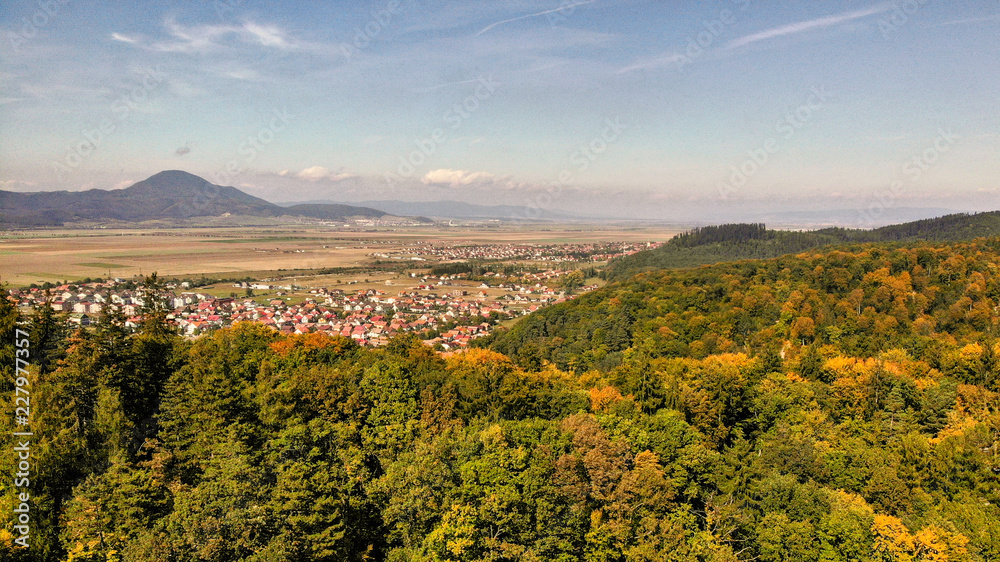 Aerial view of beautiful Transylvania. Carpathian mountains in autumn, sunset with beautiful collors and clouds.