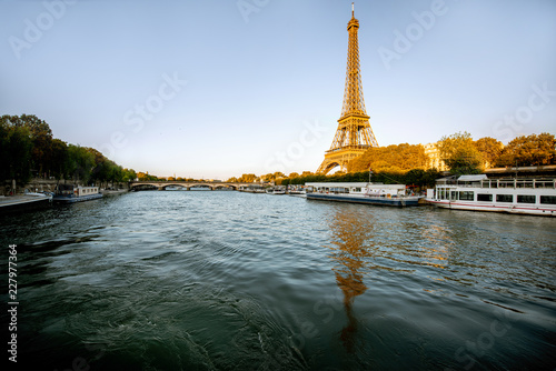 View on the Eiffel tower from the boat during the sunset in Paris