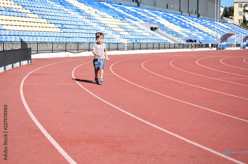Little boy on the treadmill at the stadium. Little boy on the treadmill at the stadium.