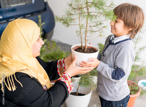 Parent potting and planting with kid