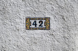 Artistic metal number on the wall near entrance door