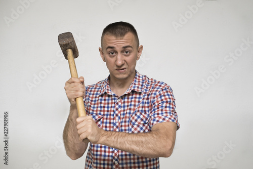 Man with a sledgehammer on a white background. Work concept