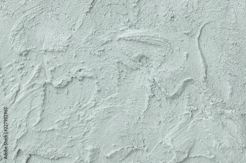 Relief stucco on the wall. Mint color. Close up