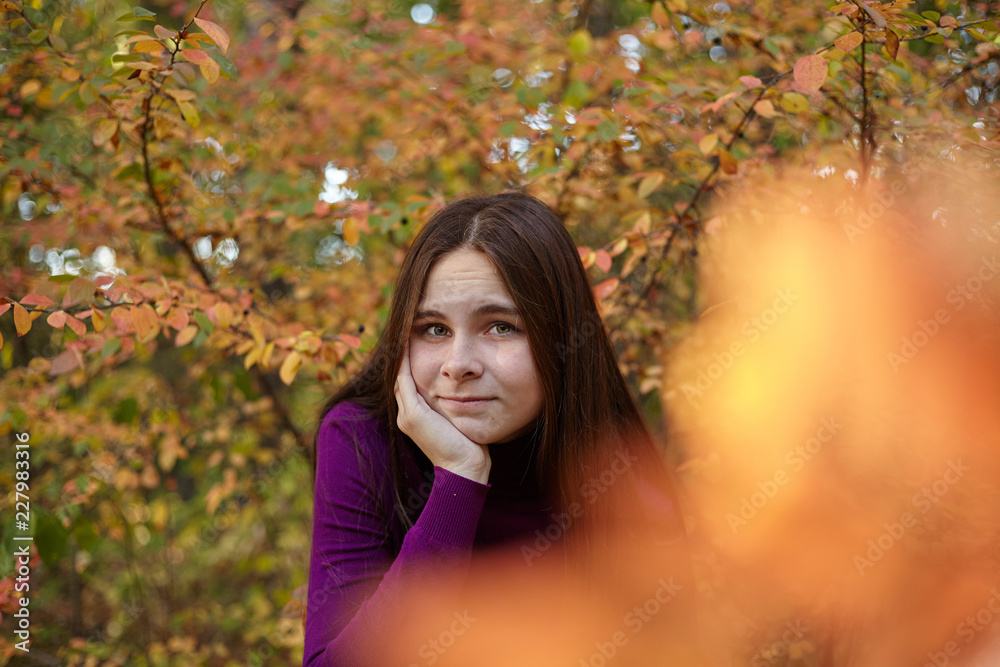 Beautiful emotional girl in autumn park.