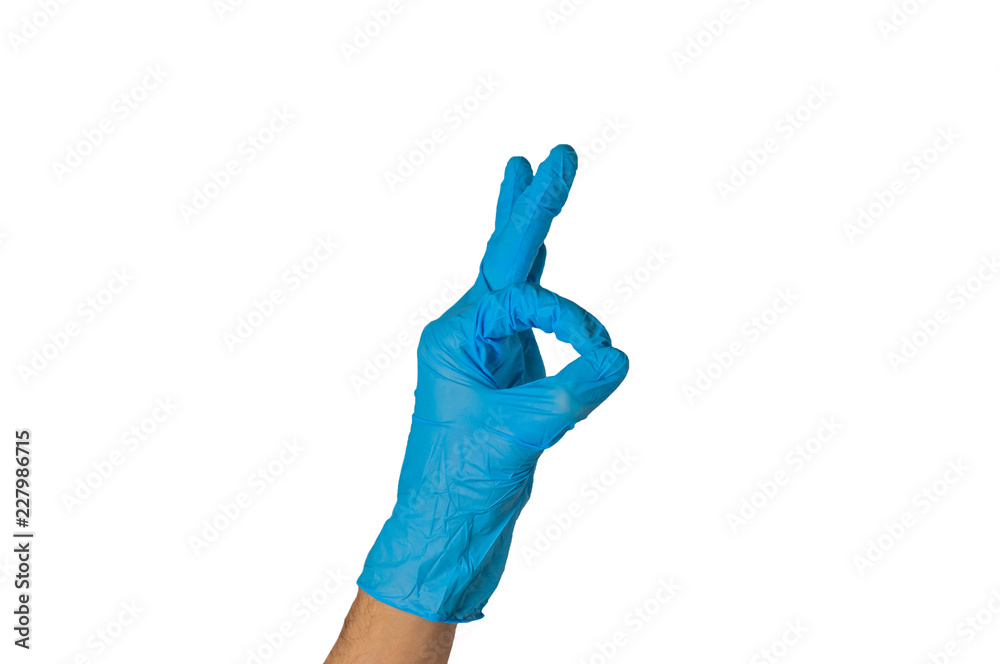 Human hand in blue rubber glove showing ok isolated on white background. Medical or cleaning concept