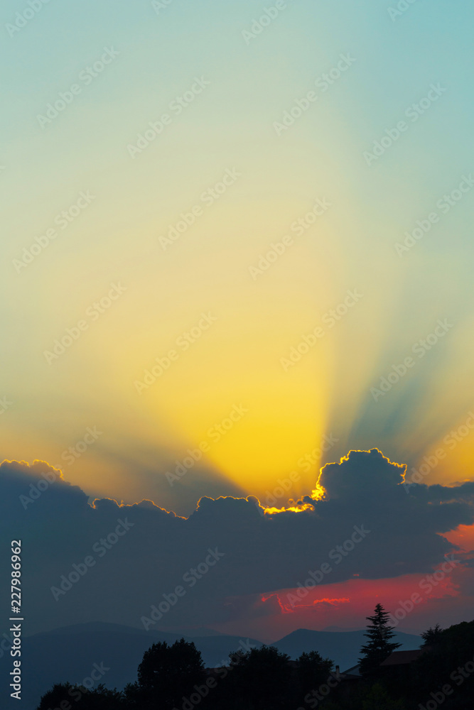 Sunbeams in the clouds at twilight, natural background Sunbeams in the clouds at twilight, natural background