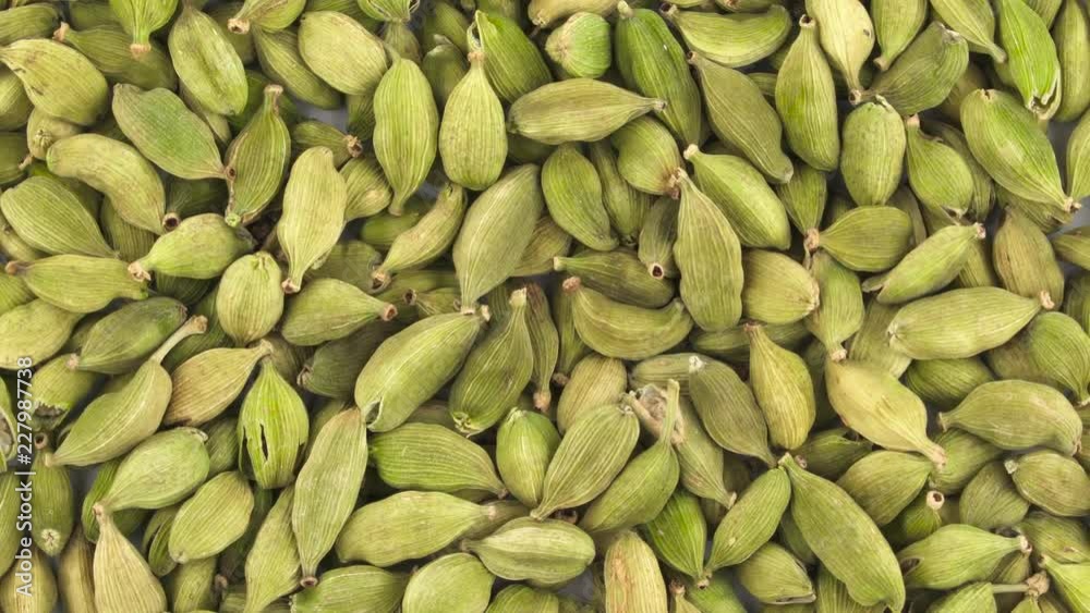 Cardamom seeds pile. Full frame. Rotating. Close up. Macro. Cardamom seeds pile. Full frame. Rotating. Close up. Macro.