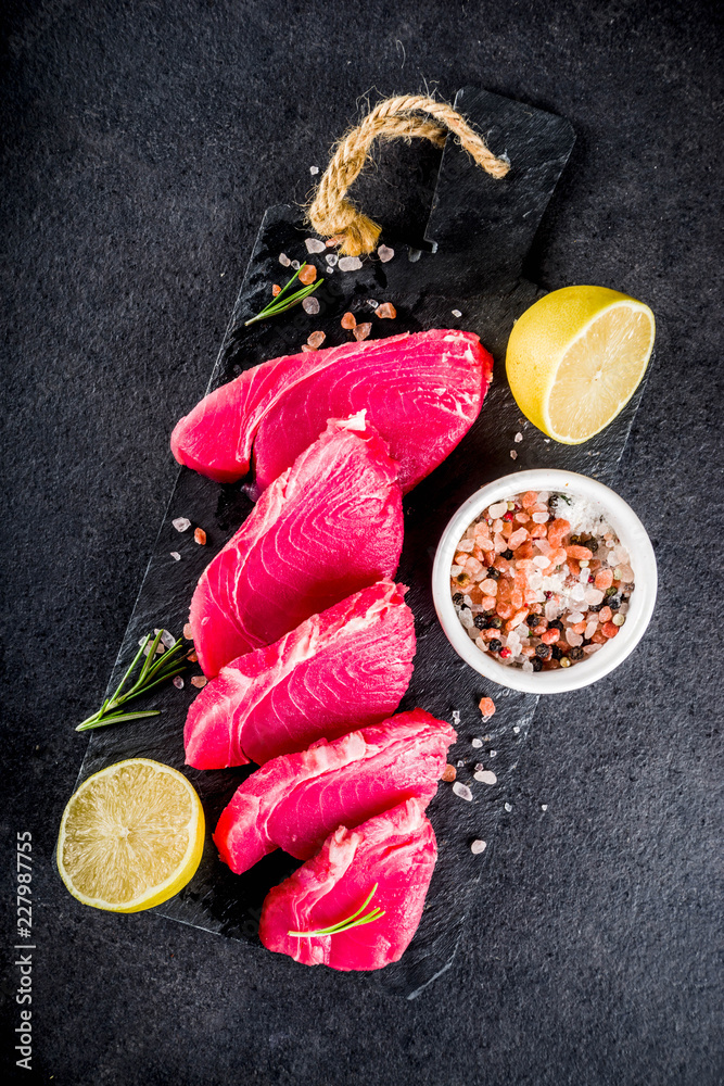 Fresh raw tuna fish steaks with ingredients for cooking