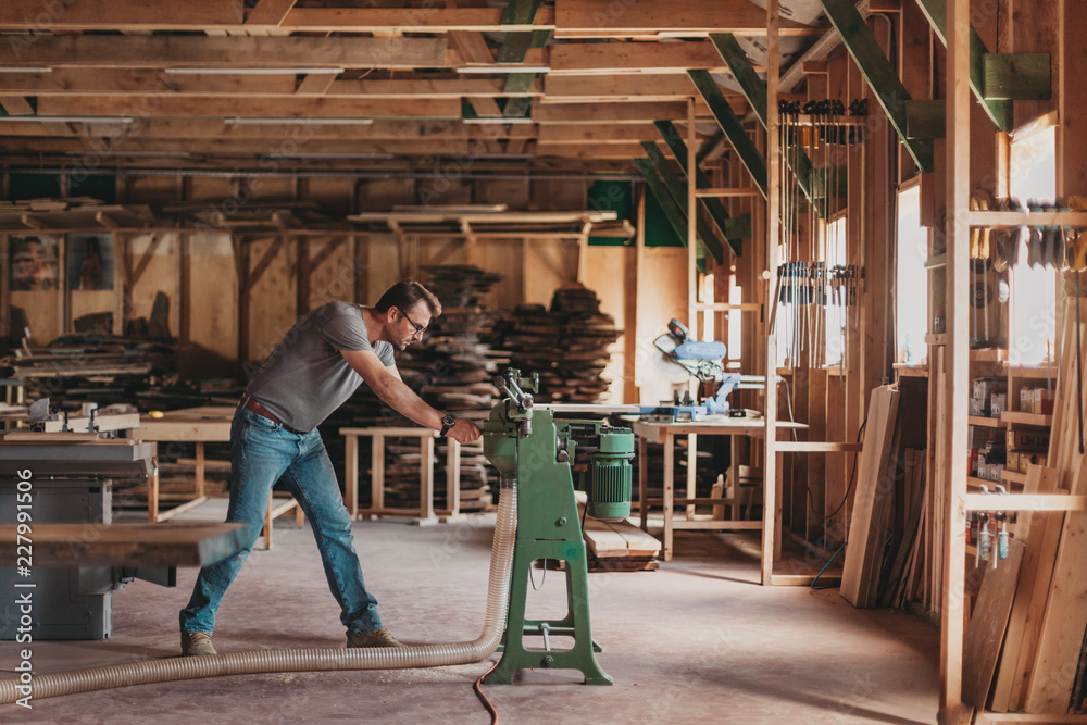 Fototapeta premium Portrait of Artisan Carpenter Working in his Workshop