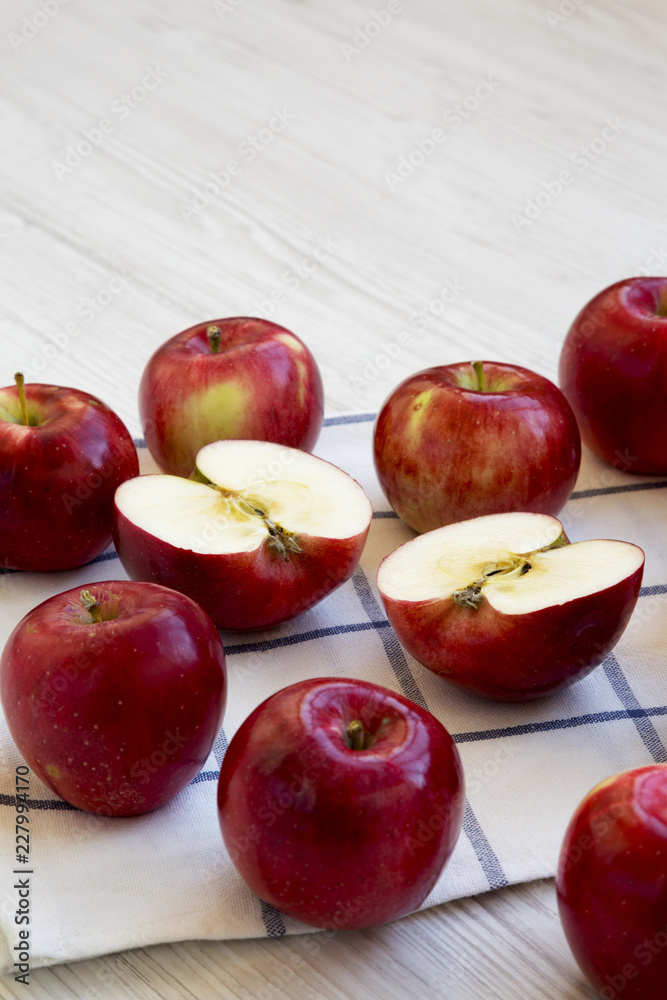 Fresh raw red apples on white wooden background, side view. Close-up. Fresh raw red apples on white wooden background, side view. Close-up.