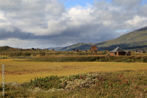 A sami village in the mountains under cloudy sky