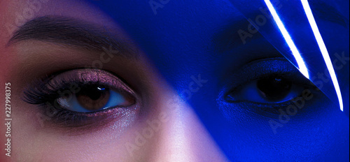 Eyes of young beautiful woman with clean perfect skin with blue filter