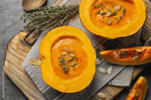 Flat lay composition with cream soup served in pumpkin on table photo