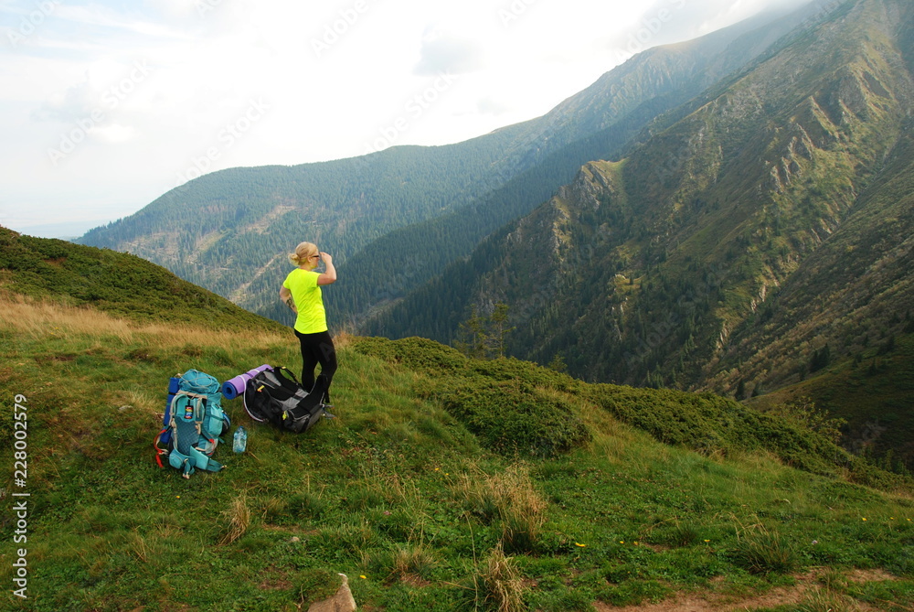 A woman by Mount Suru of Carpathian Mountains, Transylvania, Romania